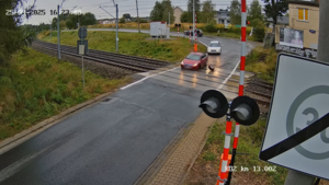 Samochód z urwanym kołem na przejeździe.